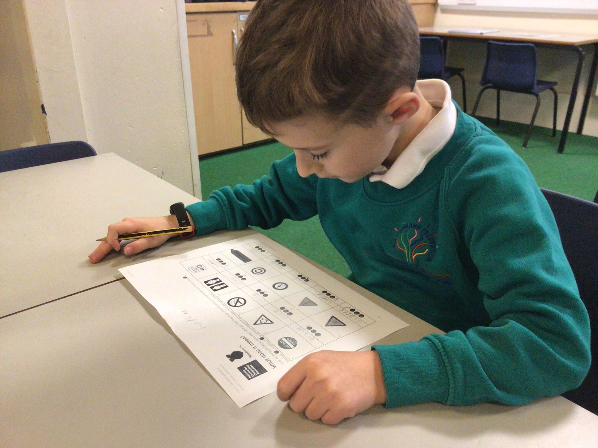 Two children writing in school work books